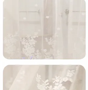Close-up detail of white floral embroidery on translucent Nordic lace window curtain