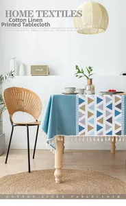 Close-up of blue cotton linen tablecloth with geometric patterns and white fringe tassels