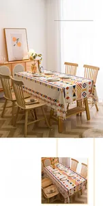 Detail of bohemian geometric print on cotton linen tablecloth with beige fringe tassels
