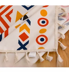 Close-up of bohemian cotton linen tablecloth featuring ethnic patterns and tassel fringe detail
