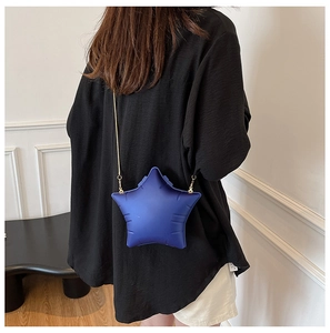 Detail showing high-quality star-shaped acrylic shoulder bag with gold chain strap for women