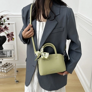 Avocado green lychee grain leather bucket bag with silk scarf and silver hardware