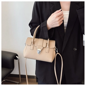 Détail du sac Boston en cuir beige à grain de litchi avec boucle en métal argenté