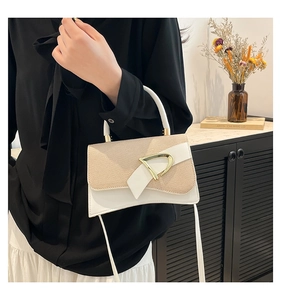 Detail of contrast stitching beige woven crossbody bag with gold D-ring buckle