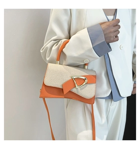 Detail of color-block tote bag featuring orange leather and beige woven texture