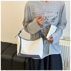 Detail of white woven hobo bag with blue leather strap and Fashion & Bag logo printing