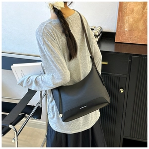 Detail of black woven texture shoulder bag with Fashion & Bag logo for daily use