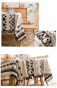 Detail of bohemian geometric print on linen tablecloth with black tassel fringe accents