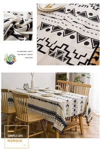 Macro detail of Nordic linen tablecloth featuring black geometric prints and fringe tassels