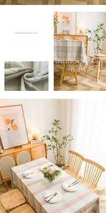 Detail of Nordic checkered tablecloth featuring decorative cotton ball tassels and linen texture
