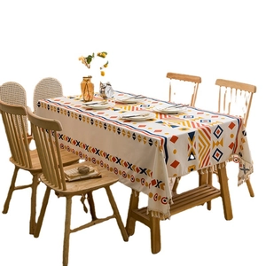 Bohemian linen tablecloth with red and blue geometric prints and cream fringe tassels