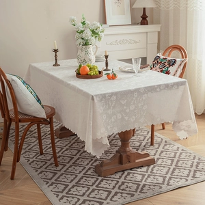 Close-up of cream rectangular tablecloth with floral jacquard and scalloped edges