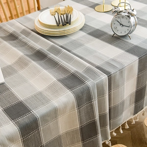 Nordic waterproof plaid tablecloth with white tassels on a wooden dining table