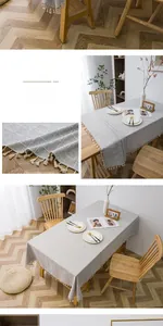 Detailed view of grey checkered linen tablecloth featuring elegant cream fringe tassels