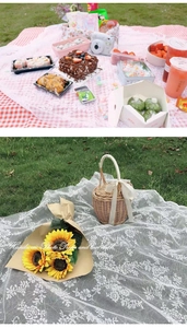 Detail of white hollow lace picnic tablecloth with rustic woven basket and sunflowers