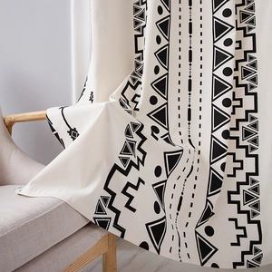 Detail of bohemian geometric print on cream linen fabric draped over a sofa