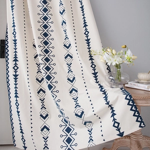 Detail of boho kitchen curtain featuring navy geometric patterns on thick linen fabric