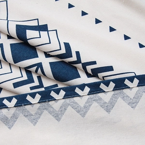 Close-up of bohemian geometric fabric showing blue patterns on cotton linen texture