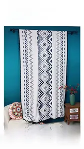 Detail of bohemian blackout curtain with blue geometric prints and black tassels decoration