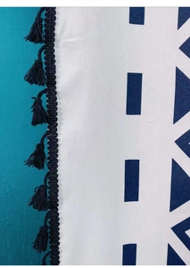 Close-up of bohemian style curtains with navy geometric prints and black tassel fringes