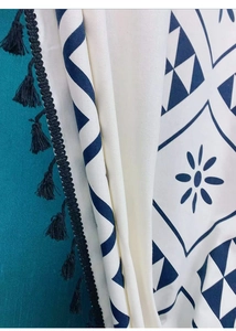 Detail of bohemian cotton linen curtain with navy geometric prints and black tassels