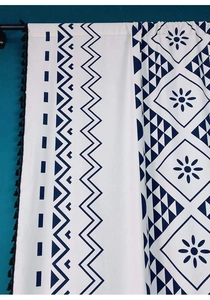 Detail view of Bohemian cotton linen curtain with navy blue prints and black tassel trim