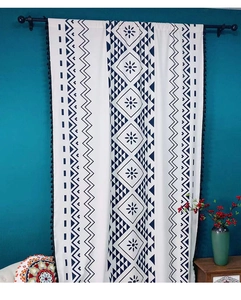 Close-up of bohemian geometric print curtain with blue tassels on thick cotton linen fabric