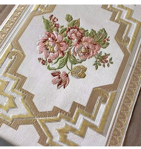 Close-up of premium embroidered chenille table runner with floral motifs and gold borders