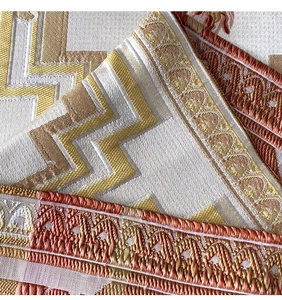 Detail of luxurious gold and bronze chenille table runner with embroidered geometric patterns