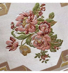 Detailed embroidery view of pink flowers and gold geometric patterns on chenille fabric