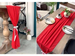 Detail of red chiffon table runner with decorative ribbon on a wooden dining table