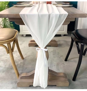 Elegant white chiffon table runner with decorative ribbon knot for wedding table decor