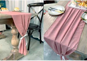 Detail of pink chiffon table runner with elegant ribbon ties for wedding decor