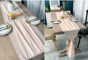 Close-up of light pink chiffon table runner with delicate edges on a wooden dining table
