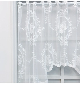 Detail of white floral lace curtain with scalloped edges and rod pocket design