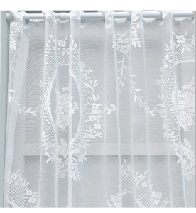 Detail of white lace curtain with elegant floral embroidery and rod pocket hanging
