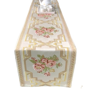Elegant floral embroidered table runner with golden patterns for home dining tables
