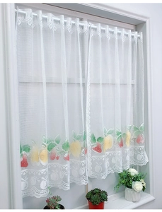 Detail of white lace short curtain with strawberry and lemon fruit print design