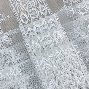 White lace table runner with floral embroidery and mesh fabric for home decor