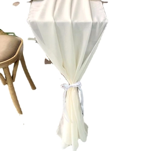 Elegant ivory chiffon table runner with decorative bow tie for wedding reception decor