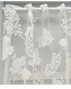 Detail of white Nordic lace curtain with intricate rose and butterfly embroidery patterns