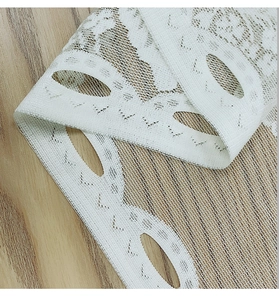 Detail of white Nordic lace curtain with floral embroidery and hollowed-out pattern
