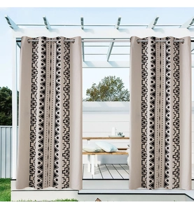 Detail of outdoor bohemian curtain with black geometric tribal patterns and metal grommets