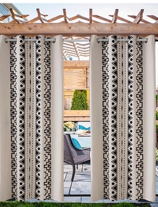 Detail of bohemian outdoor curtain with black geometric prints and silver metal grommets