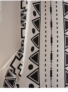 Close-up of black geometric print on white cotton linen waterproof curtain fabric