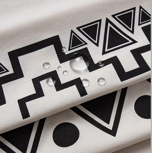 Macro detail of waterproof cotton linen fabric with bohemian geometric print and water beads