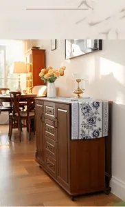 Detailed view of modern table flag featuring blue and white floral patterns and tassels