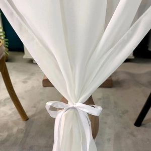 Elegant white chiffon table runner with satin ribbon bow for wedding and dining decor