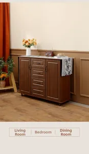 Close-up of walnut wood storage cabinet with drawers and metal handles in dining room