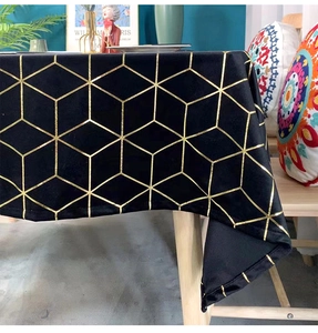 Detailed close-up of velvet table cloth featuring golden geometric honeycomb patterns